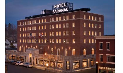 Aerial view of the Hotel Saranac lit up at dusk
