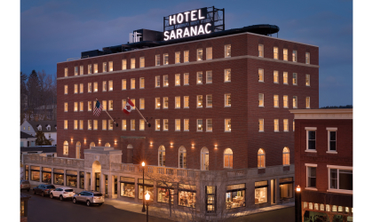 Aerial view of the Hotel Saranac lit up at dusk