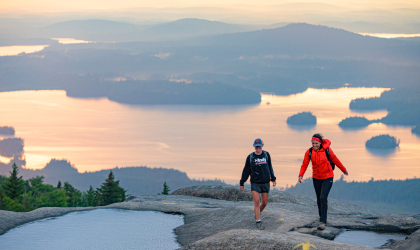 A couple people hiking Ampersand Mountain