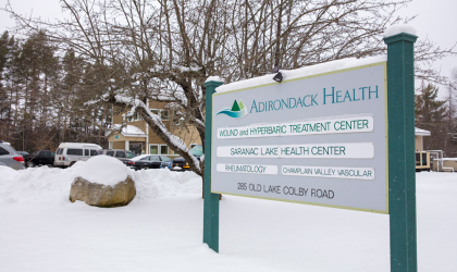 Entry sign with doctor names at the front of the Saranac Lake Health Center